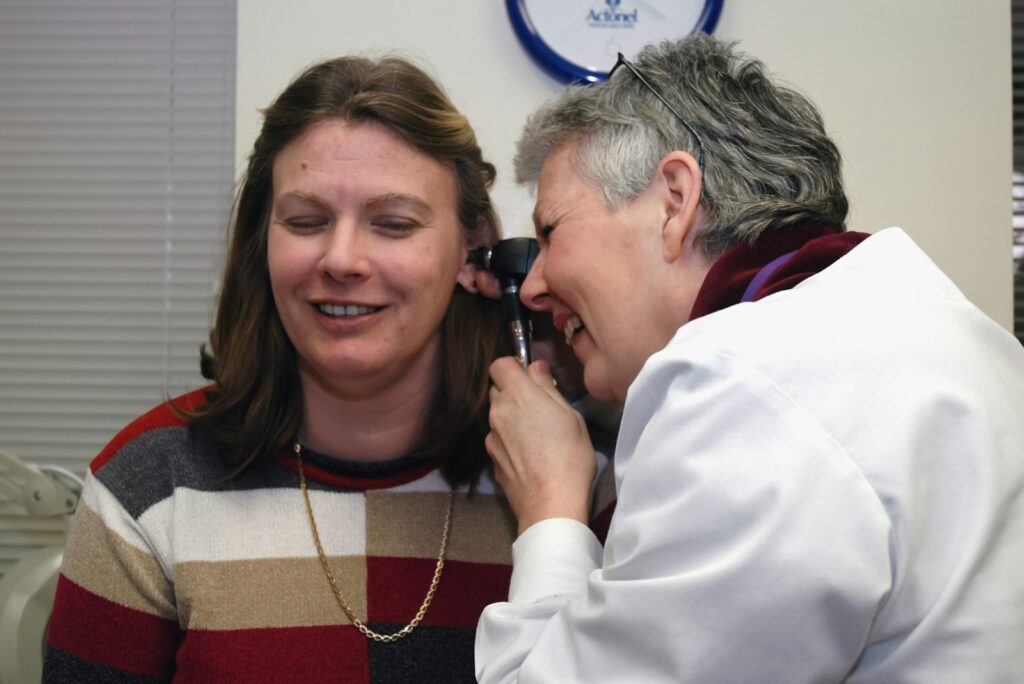 Doctor examining a patient's ear, as part of an ear health check